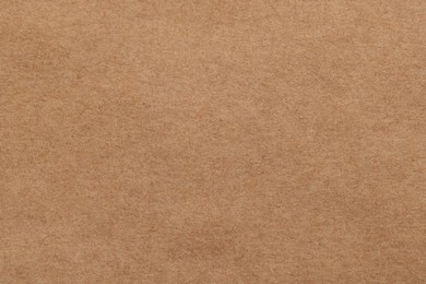 Photo of Texture of brown paper sheet as background, top view