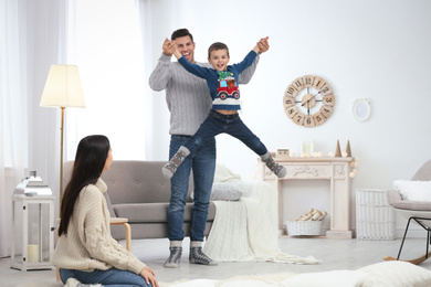 Photo of Happy family with little son having fun at home. Winter vacation