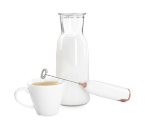 Photo of Mini mixer (milk frother), cup of coffee and bottle isolated on white