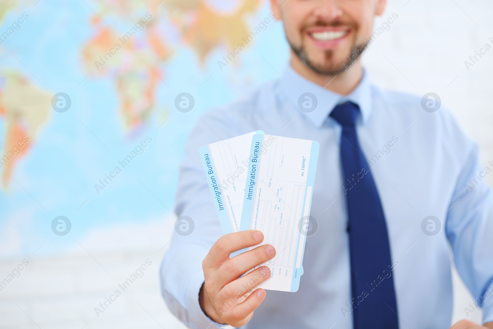 Photo of Male consultant holding tickets in travel agency, closeup. Space for text