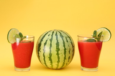 Delicious drink with mint, lime and fresh watermelon on yellow background