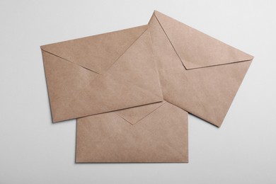 Photo of Brown paper envelopes on light grey background, flat lay