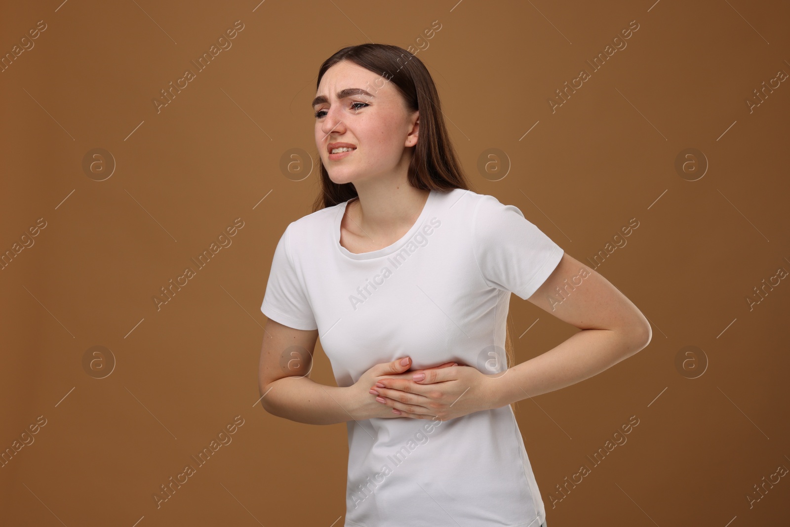 Photo of Woman having heart attack on brown background