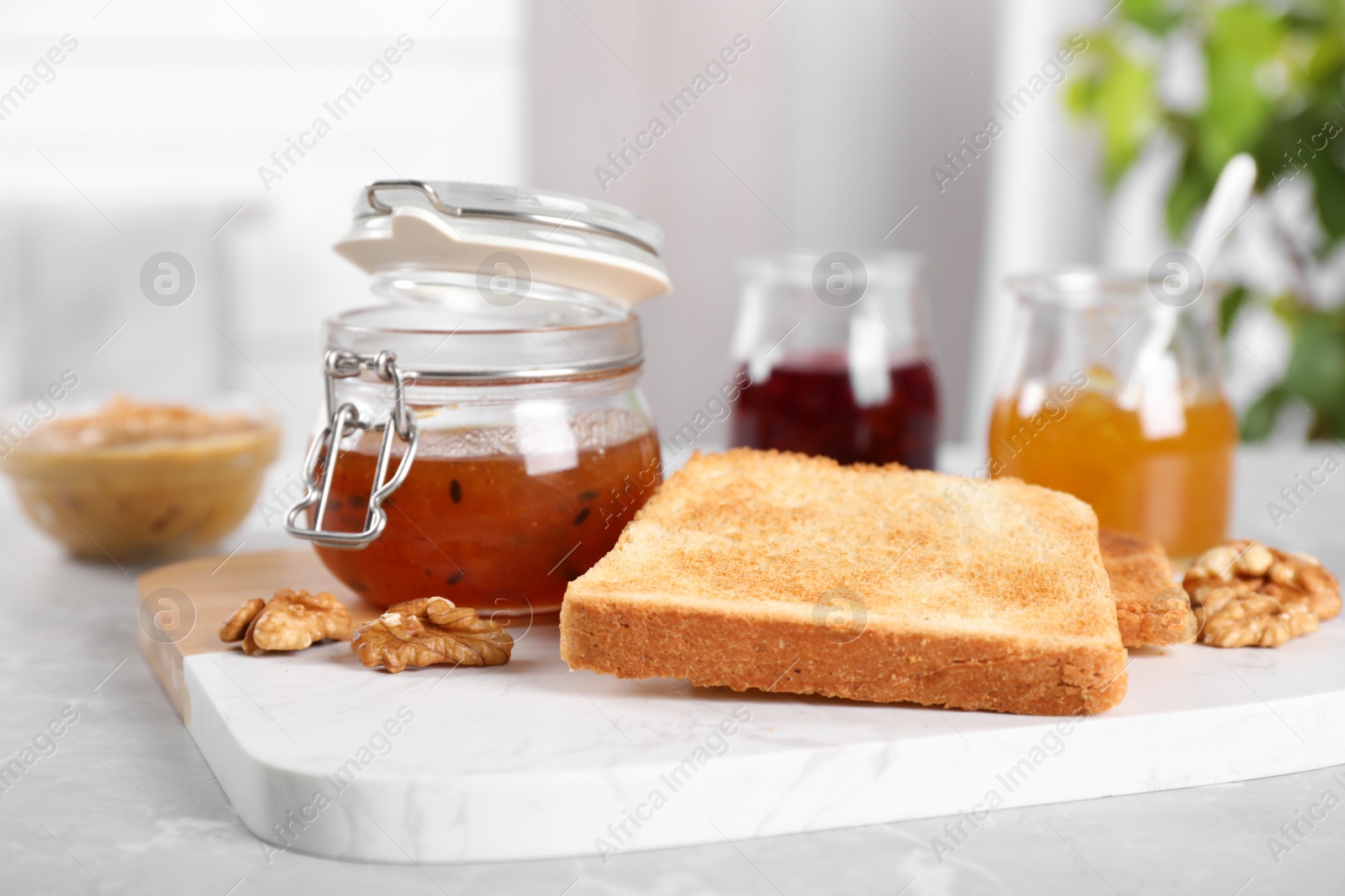 Image of Toasts, sea buckthorn jam and walnuts for breakfast on table