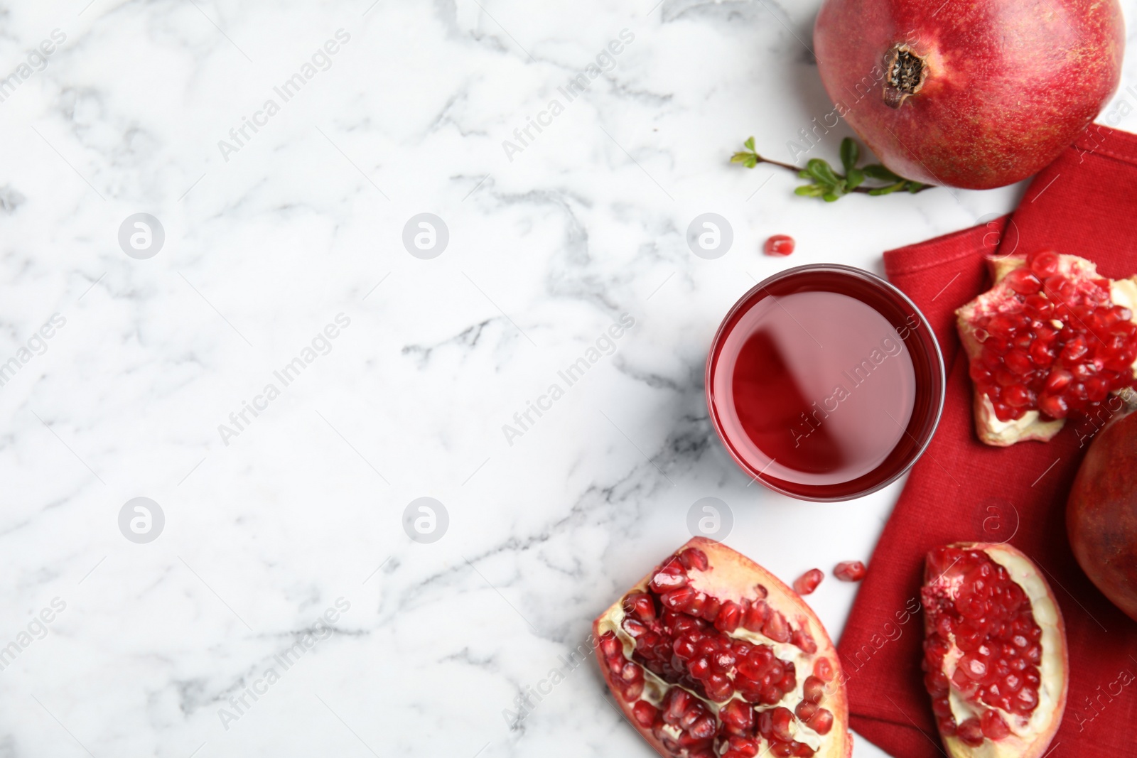 Photo of Pomegranate juice and fresh fruits on white marble table, flat lay. Space for text