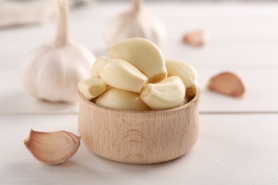 Photo of Fresh garlic on white wooden table, closeup