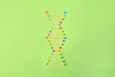 Photo of Model of DNA molecular chain on green background, top view