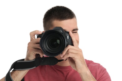 Photo of Young professional photographer taking picture on white background
