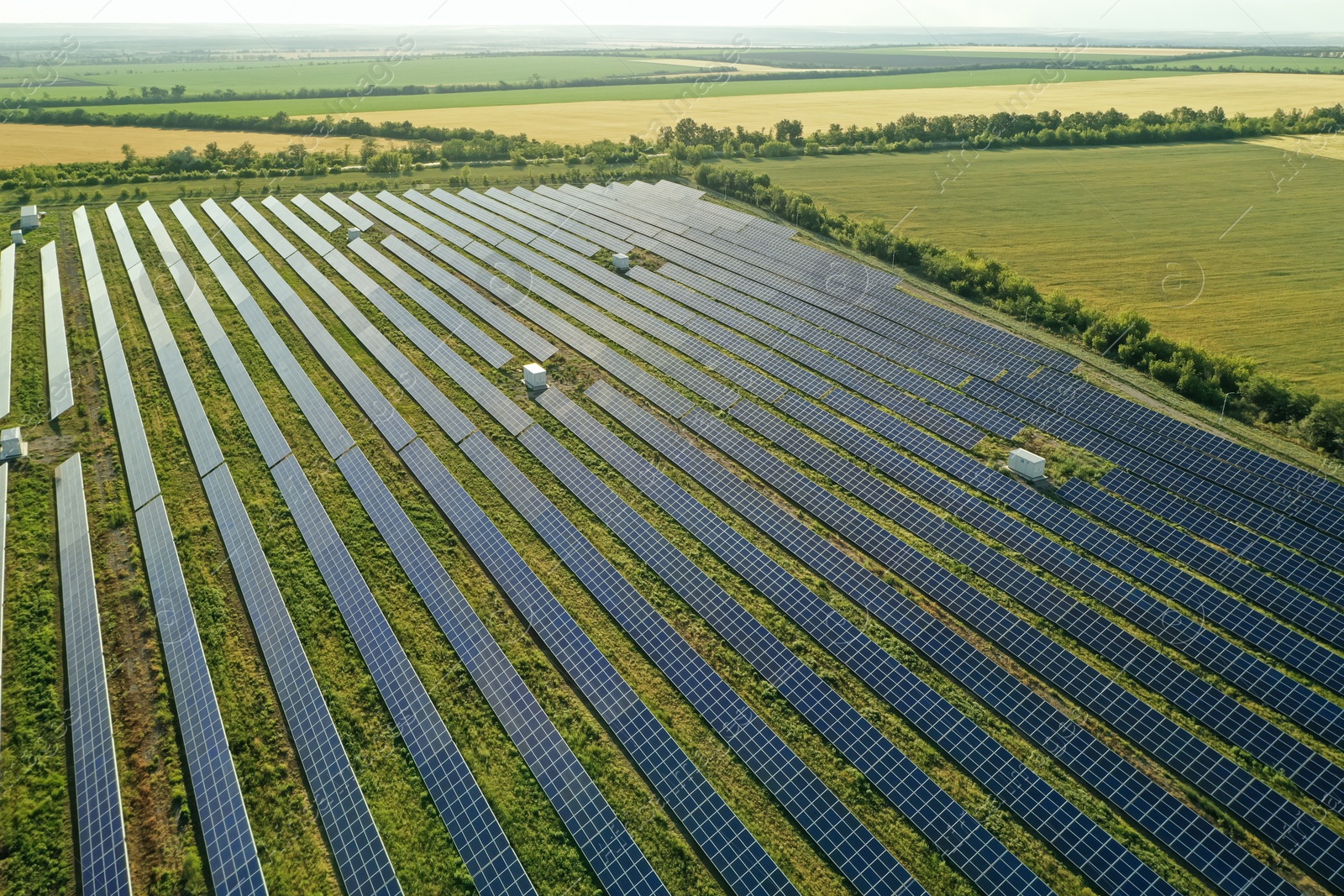 Photo of Solar panels installed outdoors, aerial view. Alternative energy source