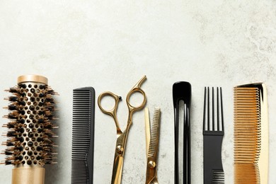 Photo of Professional hair dresser tools on grey textured background, flat lay. Space for text