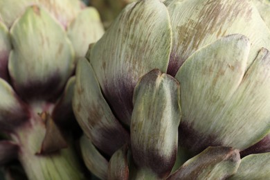 Fresh raw artichokes as background, closeup view