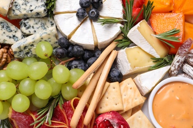 Tasty assorted appetizers as background, top view