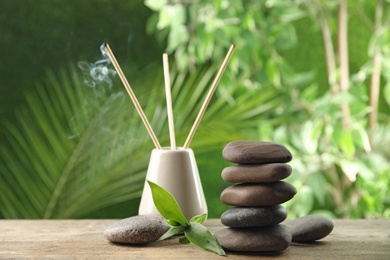 Photo of Composition with stones on table against blurred background. Zen concept