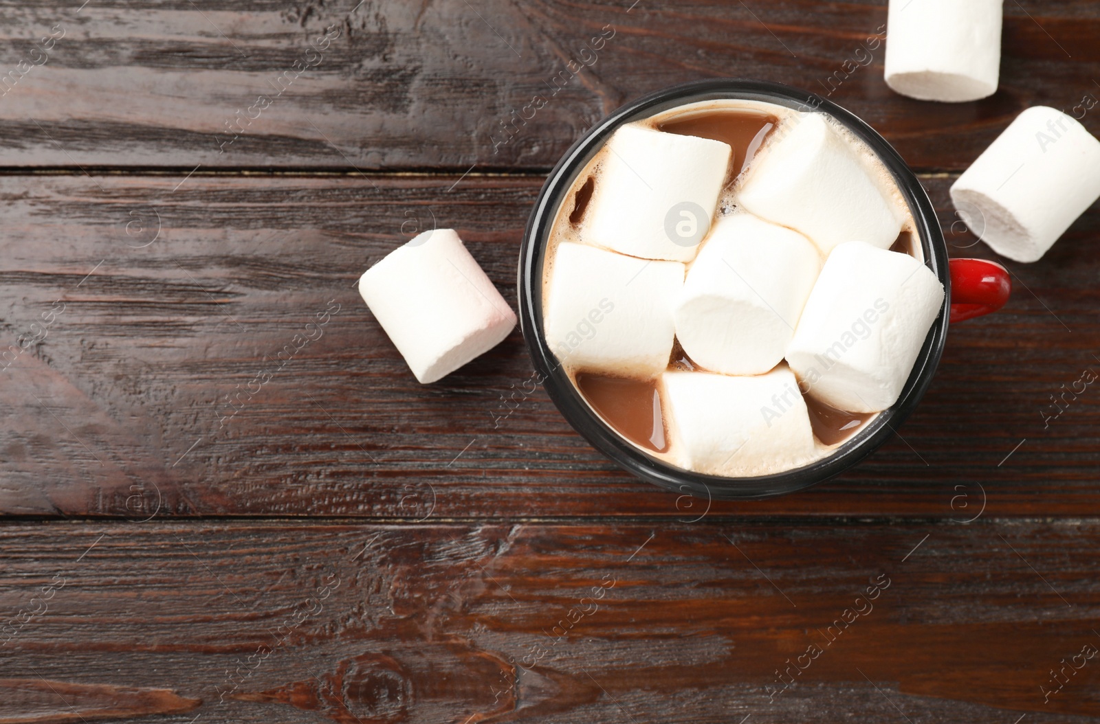 Photo of Tasty hot chocolate with marshmallows on wooden table, top view, Space for text