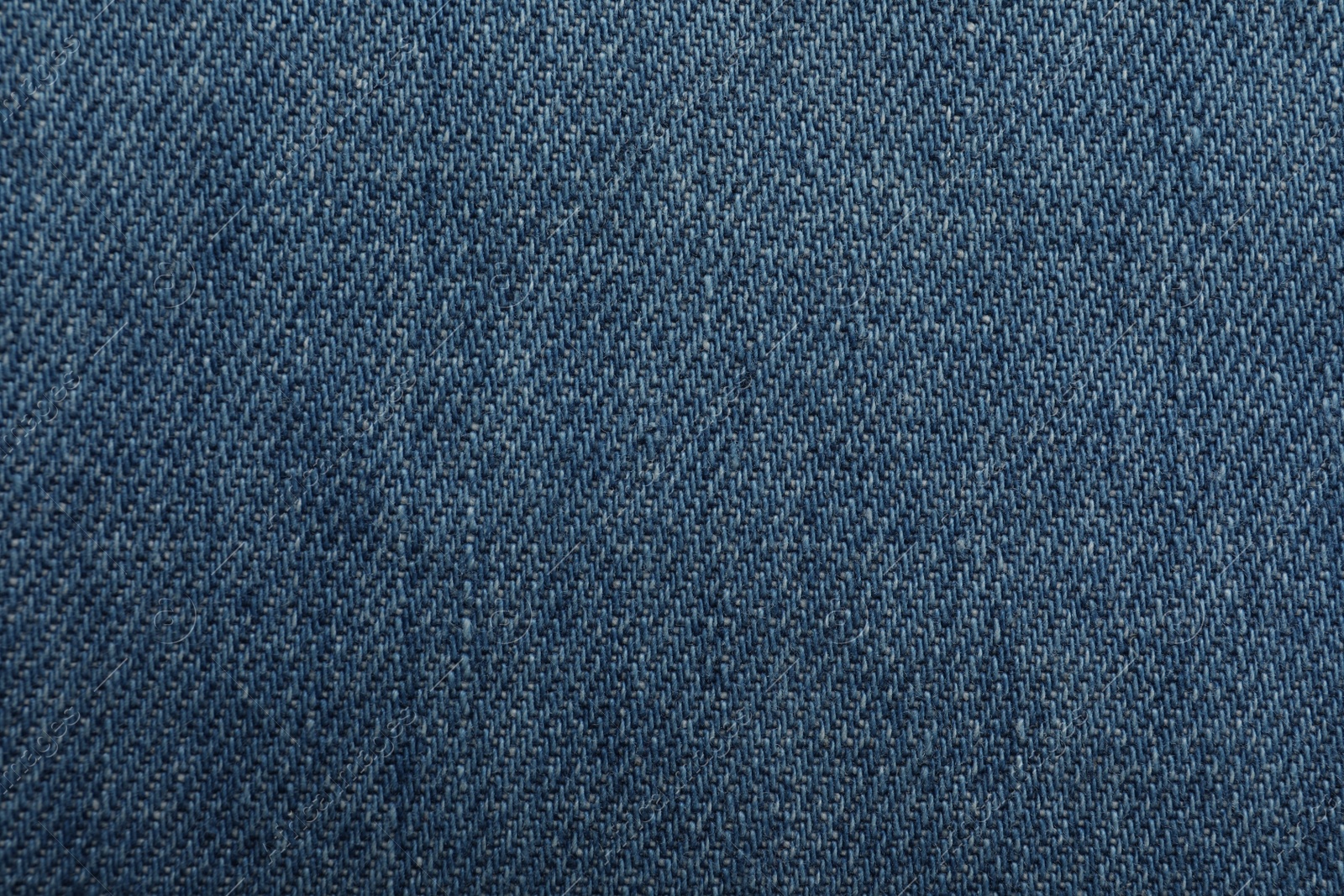 Photo of Texture of blue jeans as background, closeup