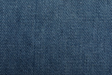 Photo of Texture of blue jeans as background, closeup