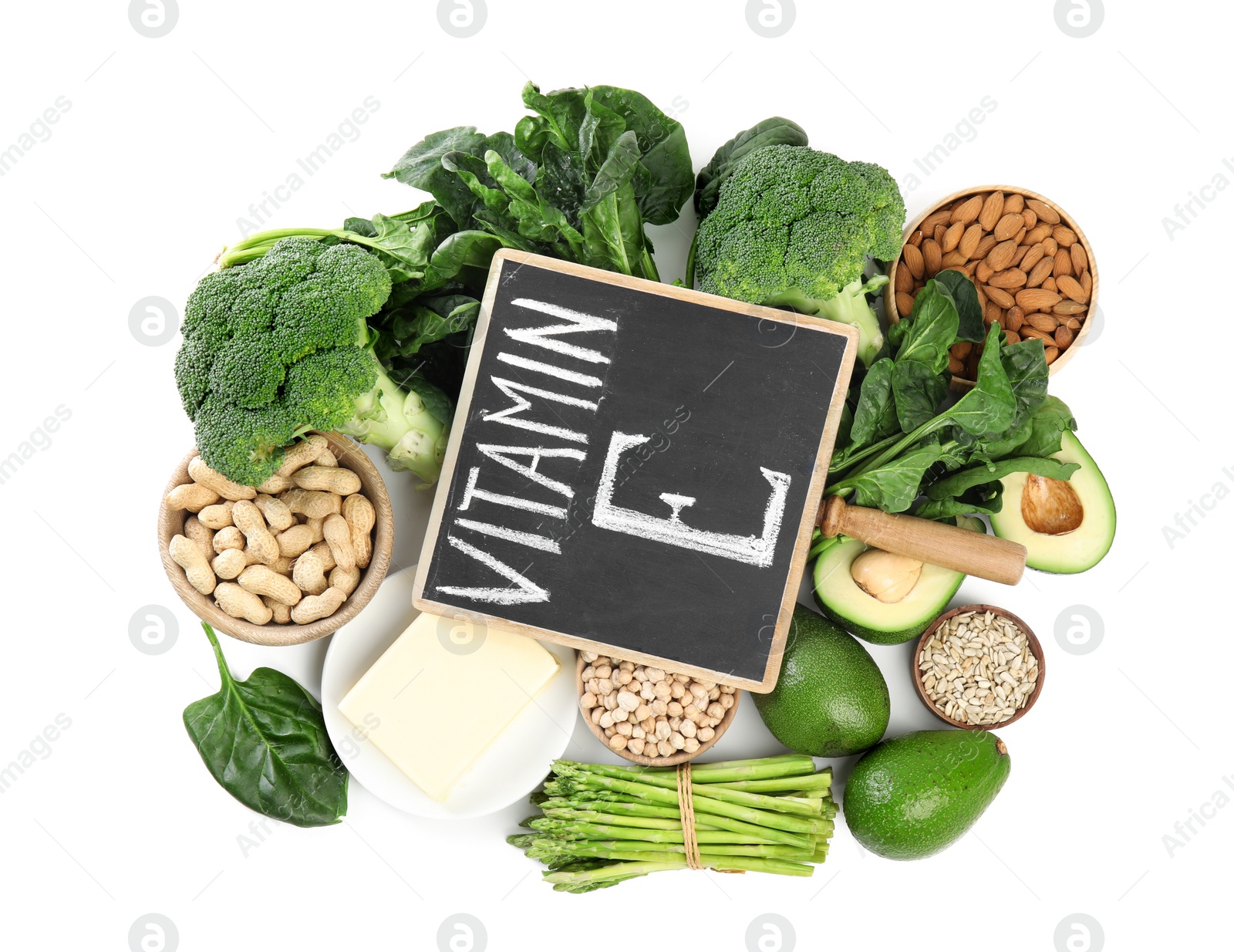 Photo of Small chalkboard with phrase Vitamin E and different products on white background, top view