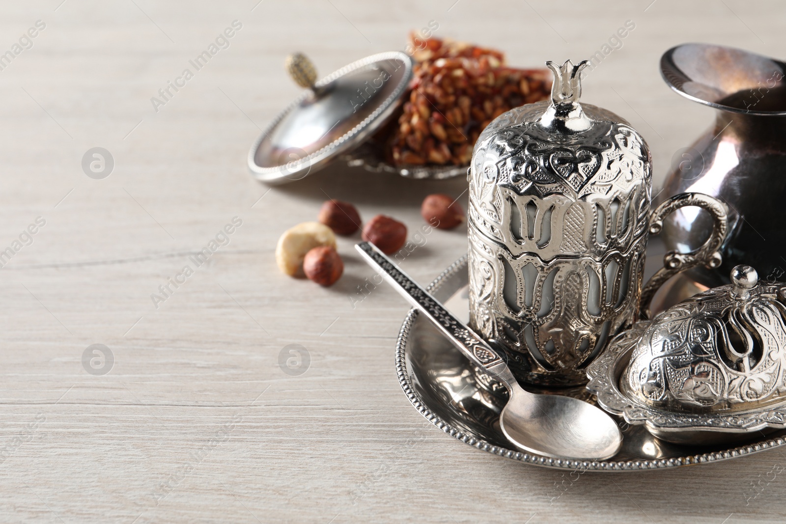 Photo of Tea and Turkish delight served in vintage tea set on wooden table, space for text