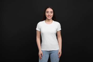 Woman wearing white t-shirt on black background