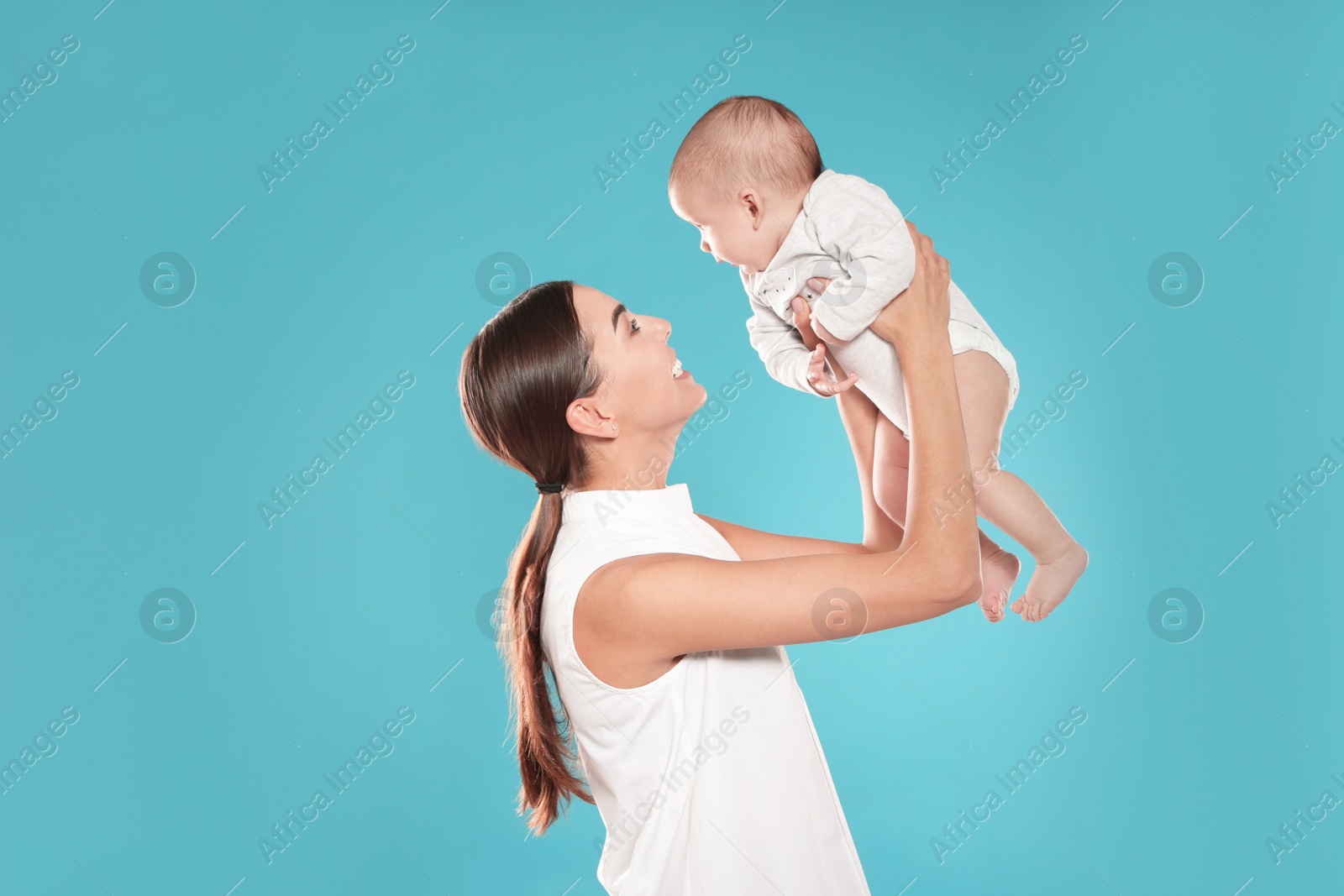 Photo of Portrait of happy mother with her baby on color background