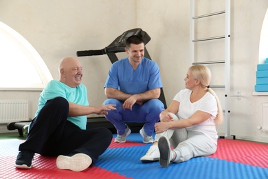 Photo of Patients with physiotherapist in modern rehabilitation center