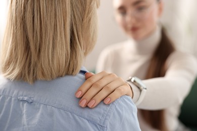 Photo of Psychotherapist working with patient in office, selective focus