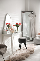 Stylish room interior with elegant dressing table and mirror