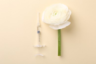 Photo of Cosmetology. Medical syringe and ranunculus flower on yellow background, flat lay