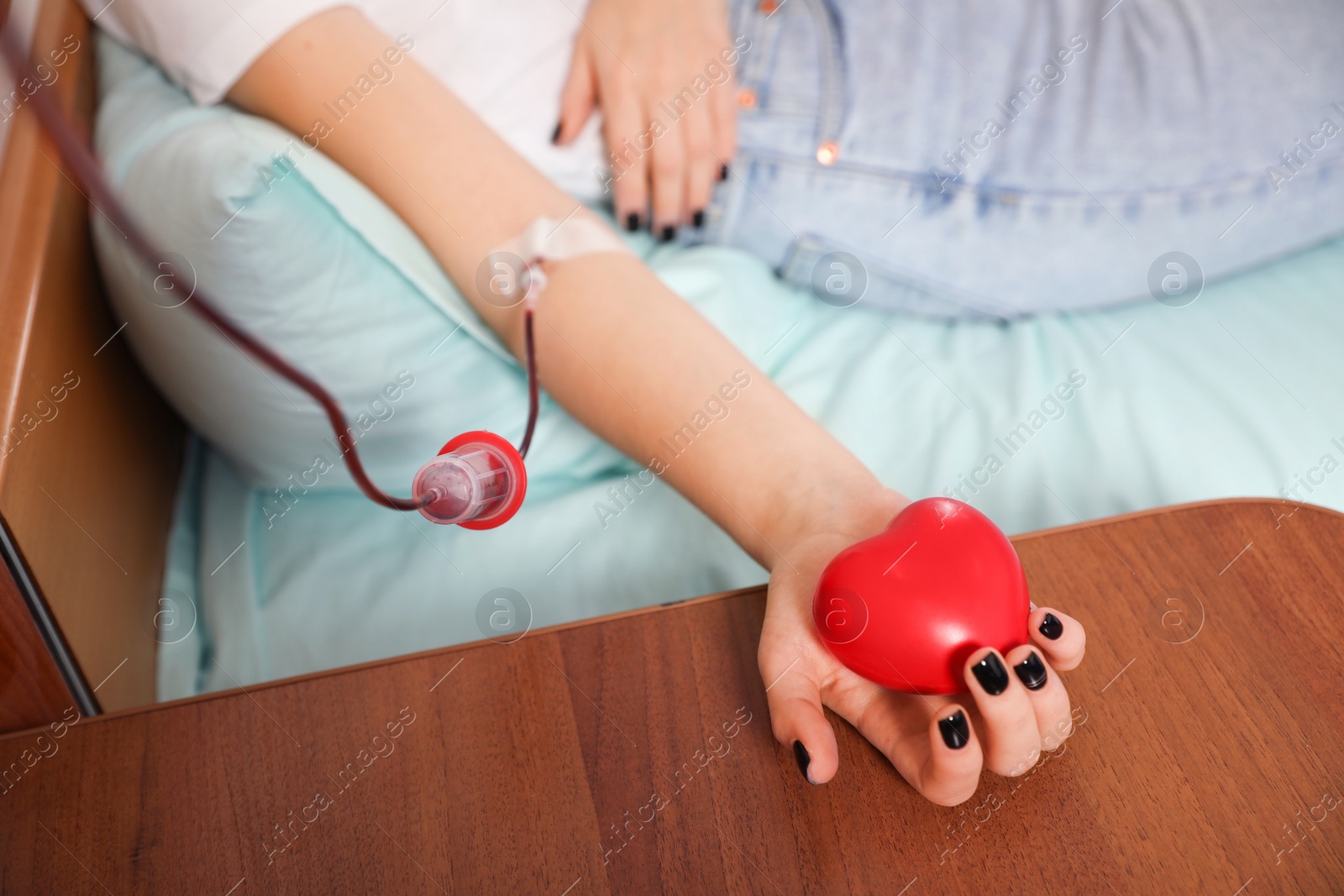 Photo of Teenager donating blood in hospital, closeup view