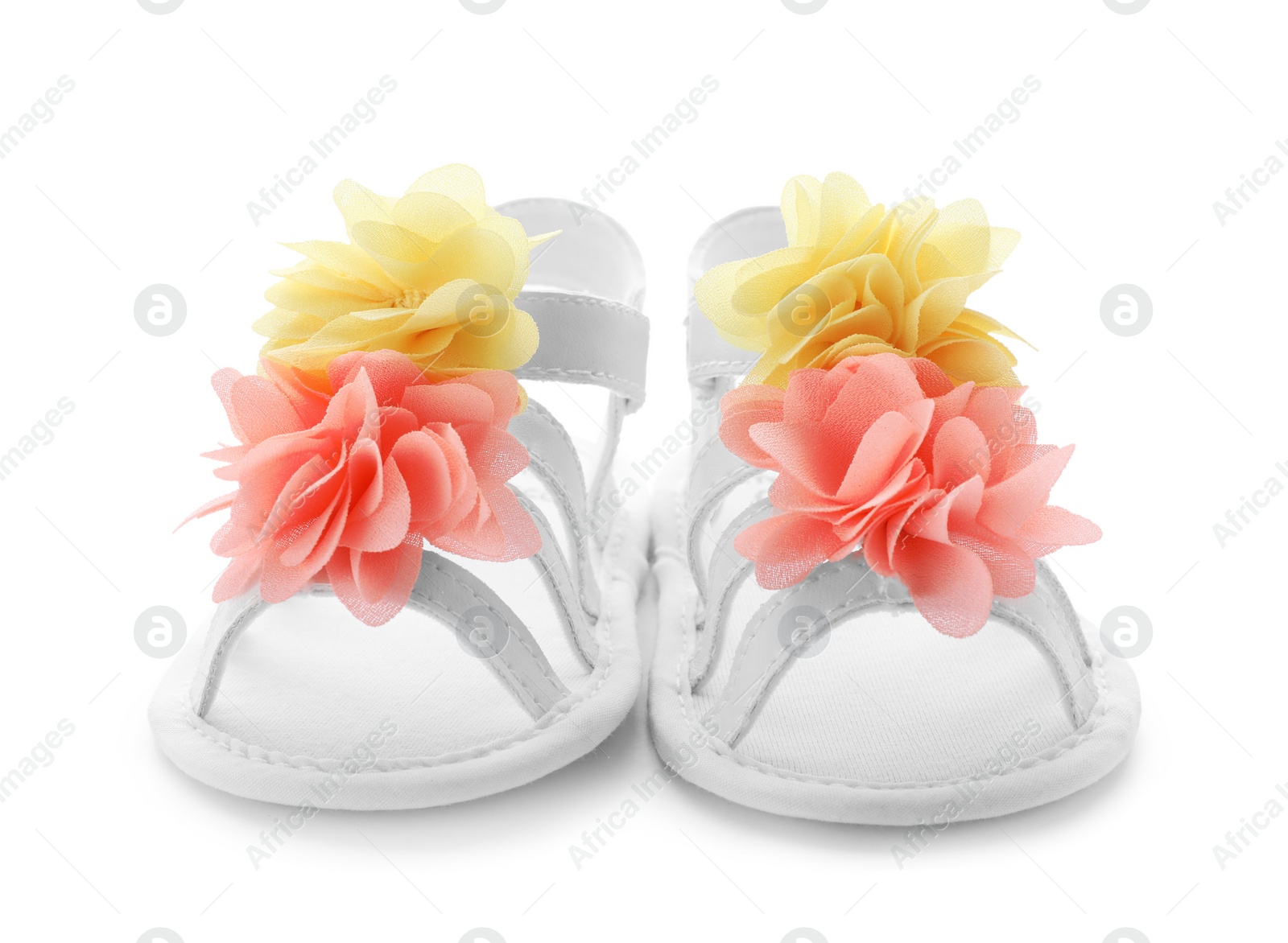 Photo of Pair of baby sandals decorated with flowers on white background