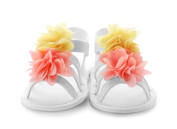 Photo of Pair of baby sandals decorated with flowers on white background