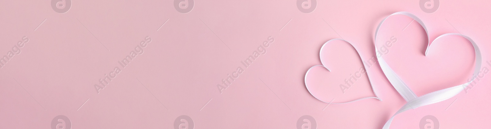 Image of Hearts made of white ribbon on pink background, flat lay. Valentine's Day banner design