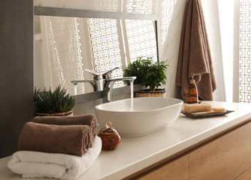 Photo of Modern bathroom interior with stylish mirror and vessel sink