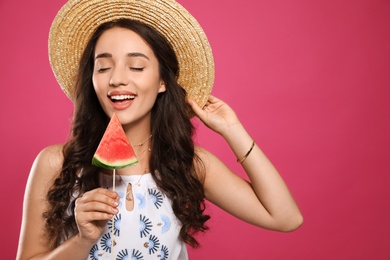 Photo of Beautiful young woman with watermelon on pink background