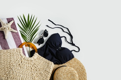 Composition with stylish beach accessories on white background, top view