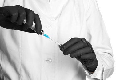 Doctor in medical gloves with syringe and ampoule, closeup