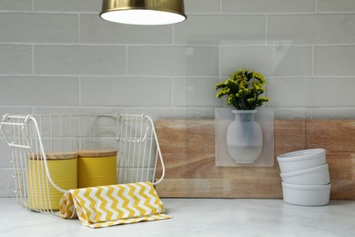 Silicone vase with flowers on countertop in kitchen