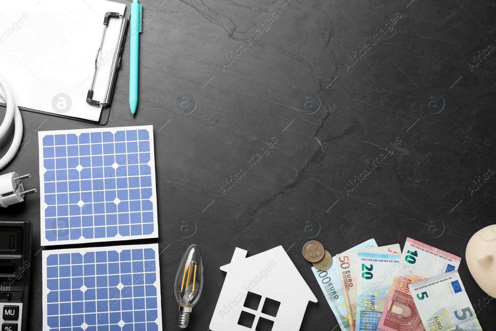 Photo of Flat lay composition with solar panels and money on black table. Space for text