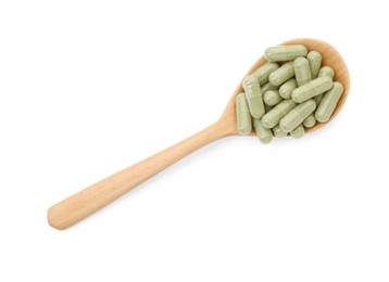 Vitamin capsules in wooden spoon isolated on white, top view. Health supplement