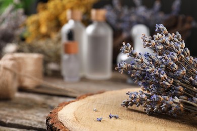 Photo of Closeup view of dry lavender flowers on wooden table, space for text. Medicinal herbs