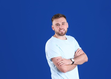 Photo of Portrait of handsome happy man on color background