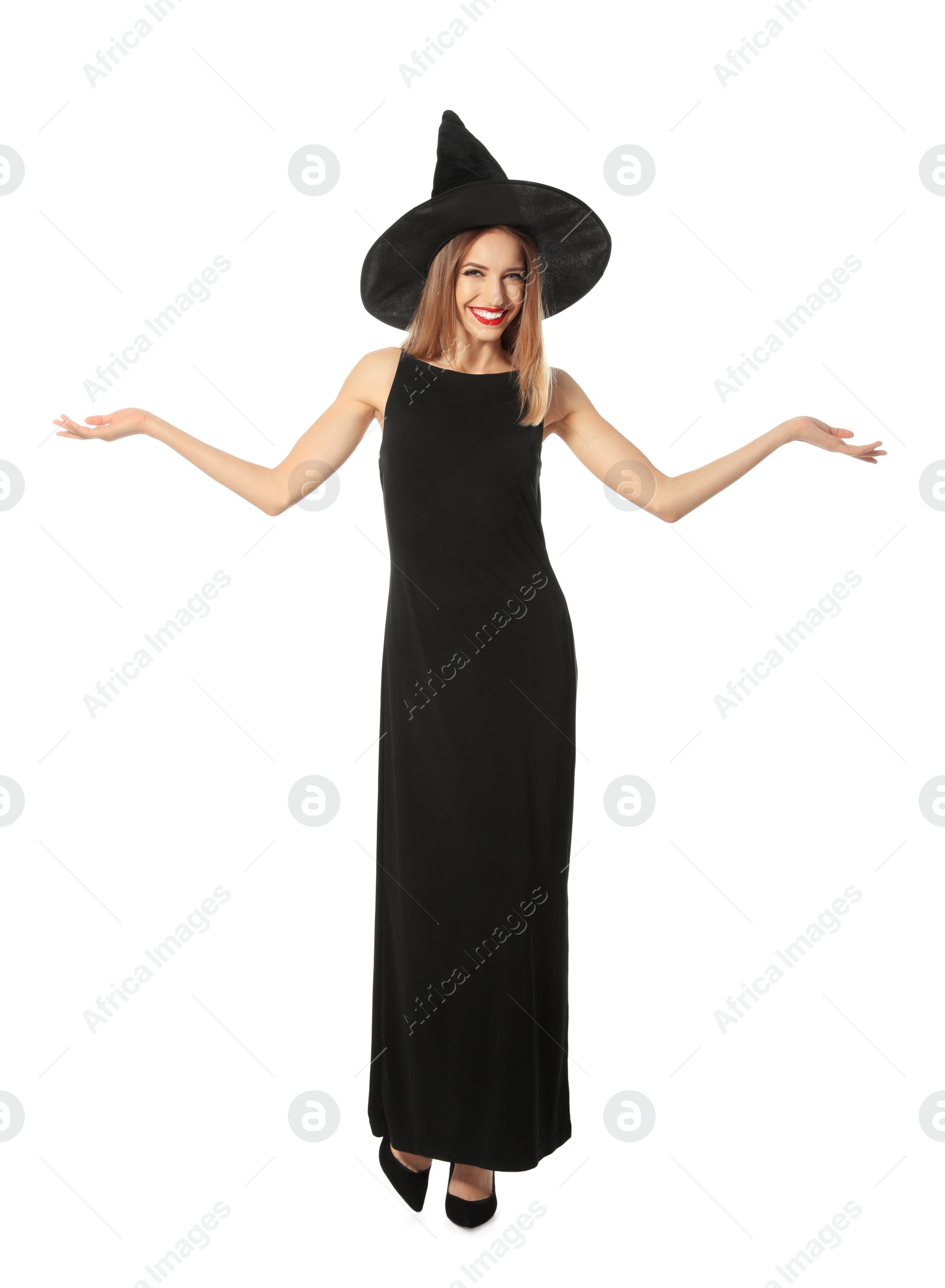 Photo of Beautiful young woman wearing witch costume for Halloween party on white background