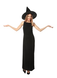 Beautiful young woman wearing witch costume for Halloween party on white background