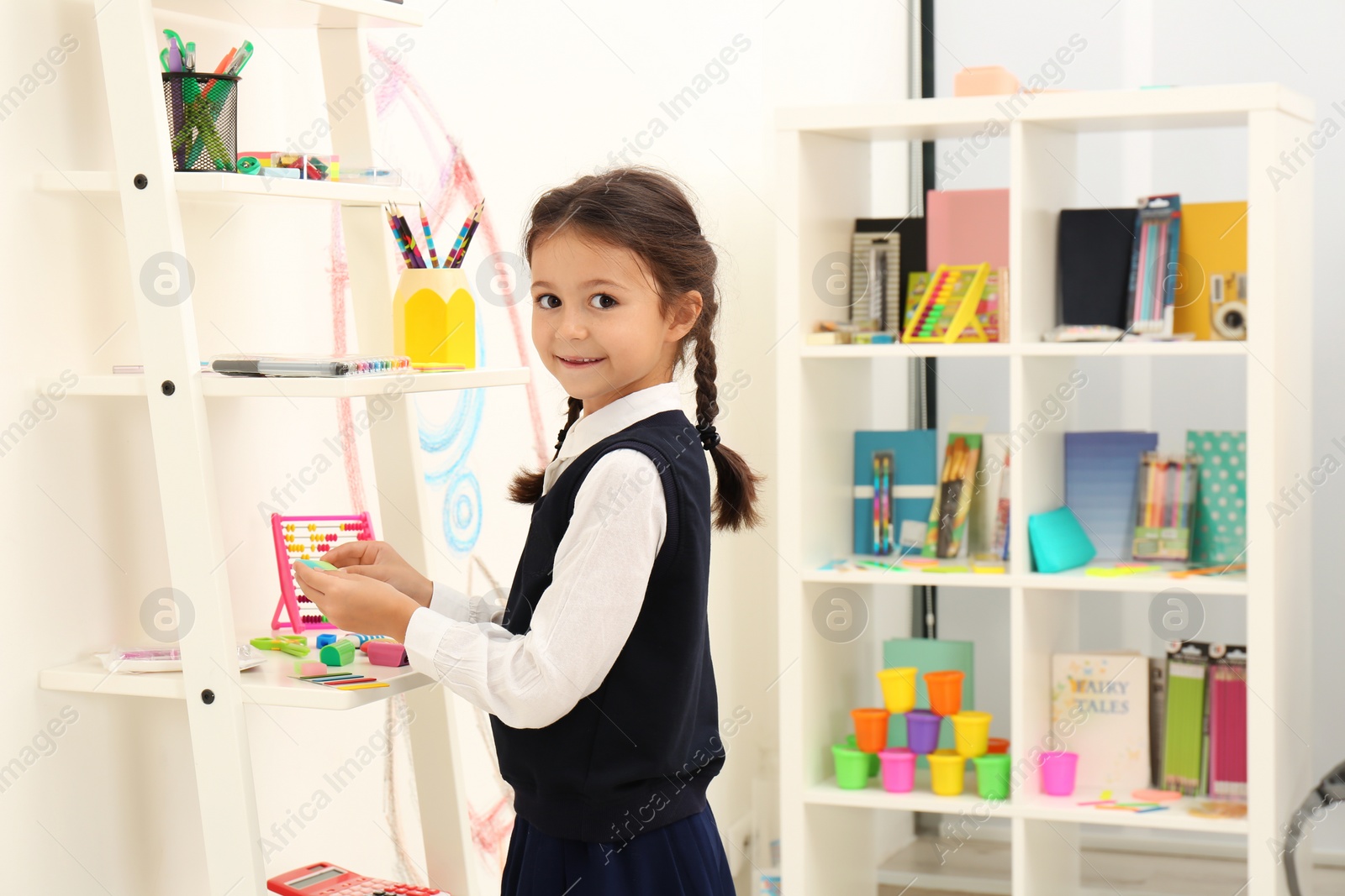 Photo of Cute child choosing school stationery in store