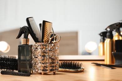 Set of hairdresser tools on table in salon, space for text