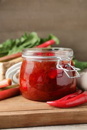 Photo of Tasty rhubarb sauce and ingredients on wooden board