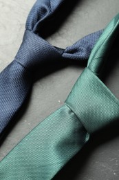 Photo of Two neckties on grey textured table, above view