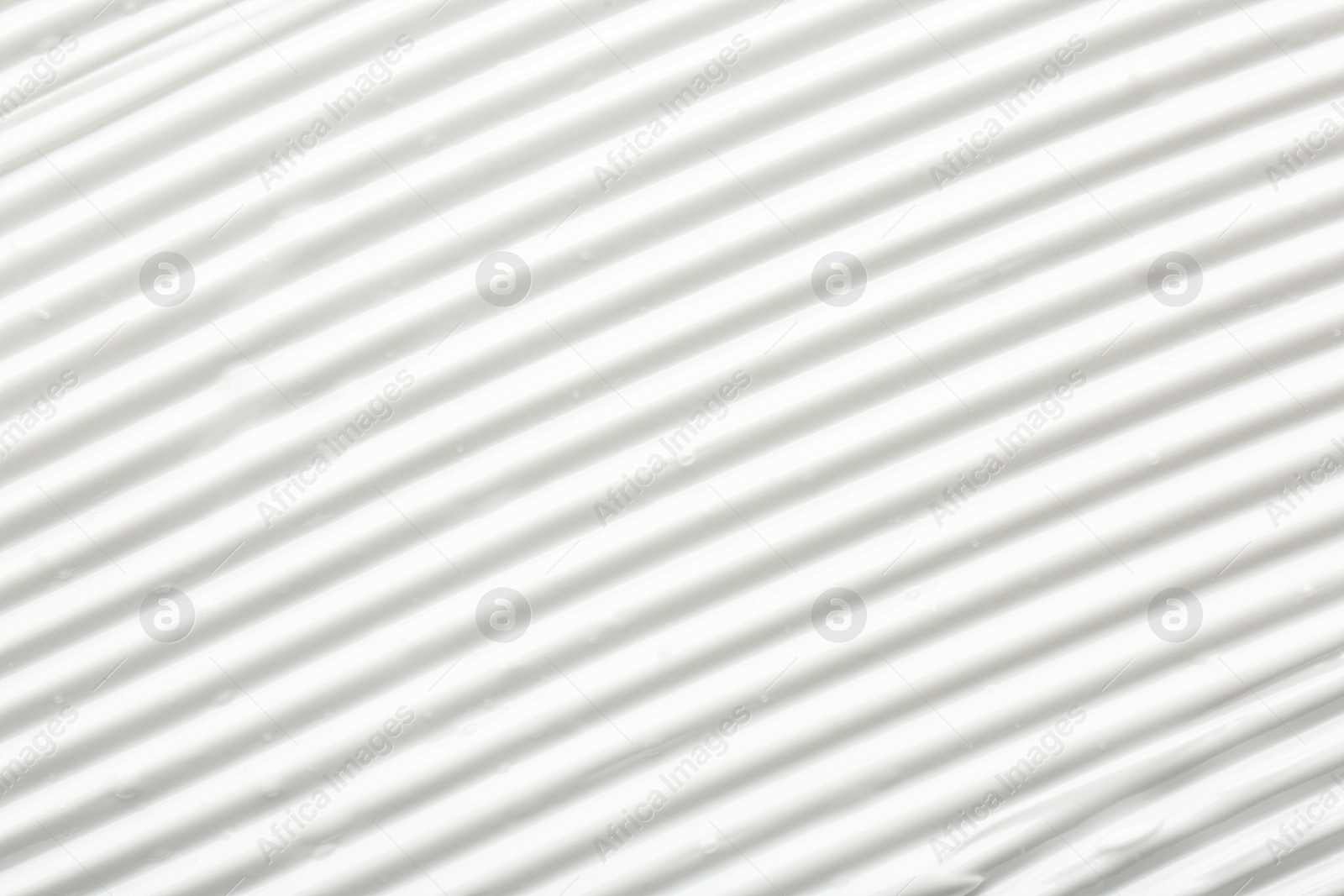 Photo of Texture of face care cream as background, top view