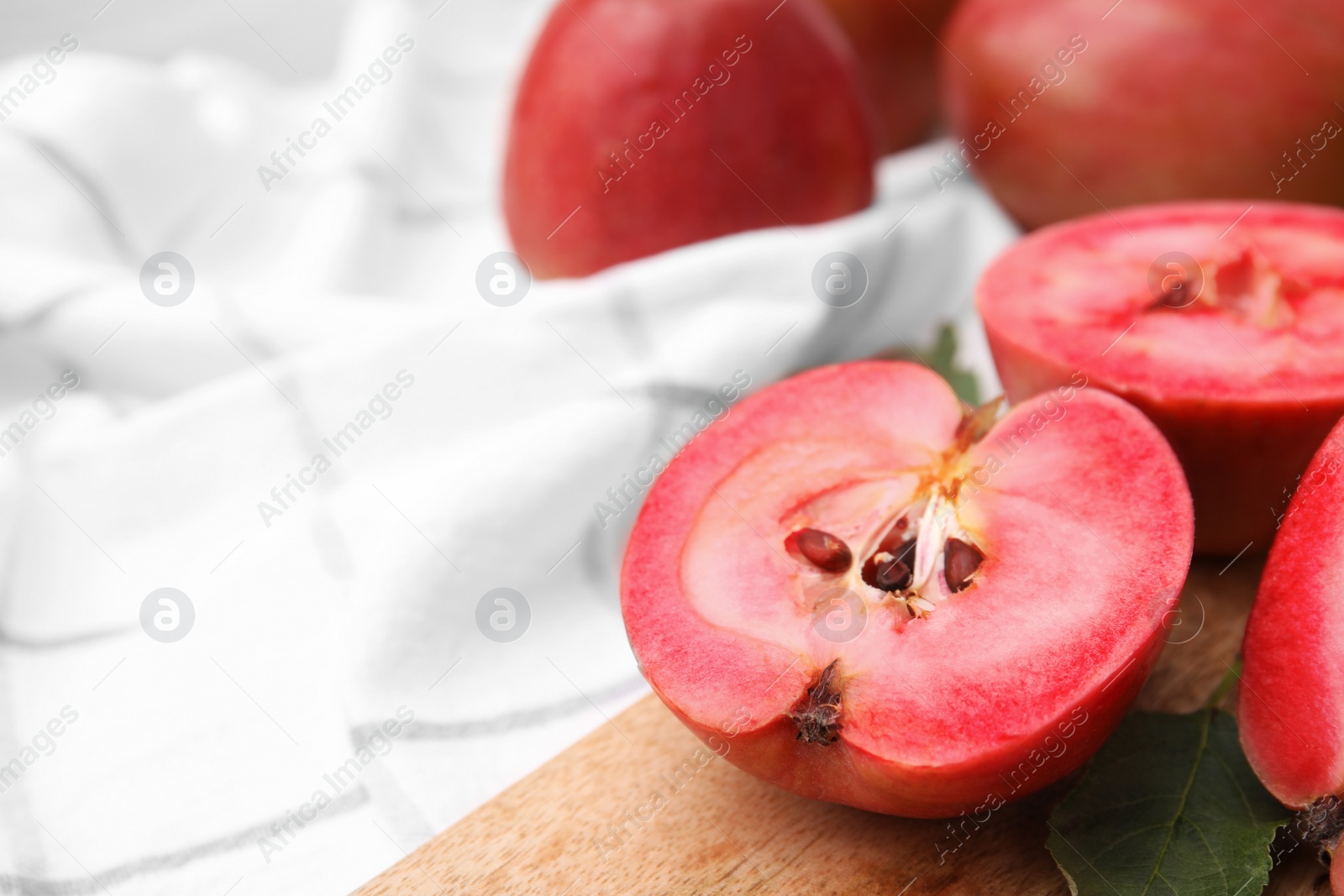 Photo of Tasty apples with red pulp on table, closeup. Space for text