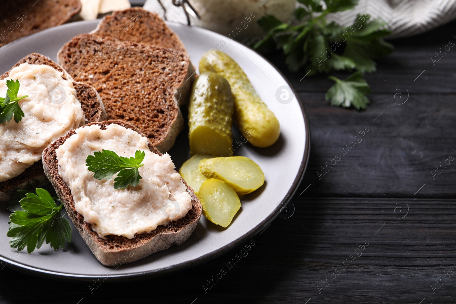 Photo of Delicious sandwiches with lard spread on black wooden table, closeup